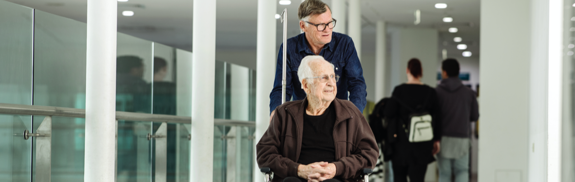 Patient in a wheelchair and his carer at Austin Hospital